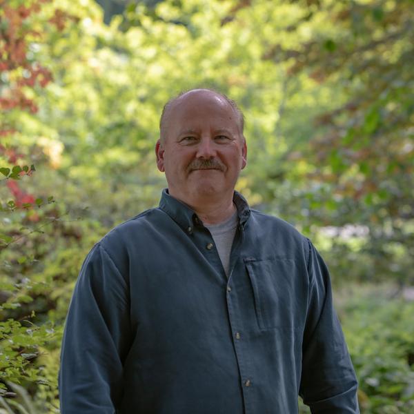 Man standing in garden posing for a staff photo
